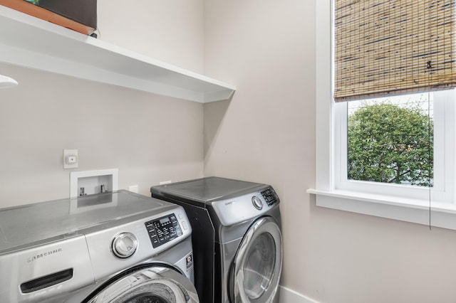 clothes washing area featuring washer and dryer