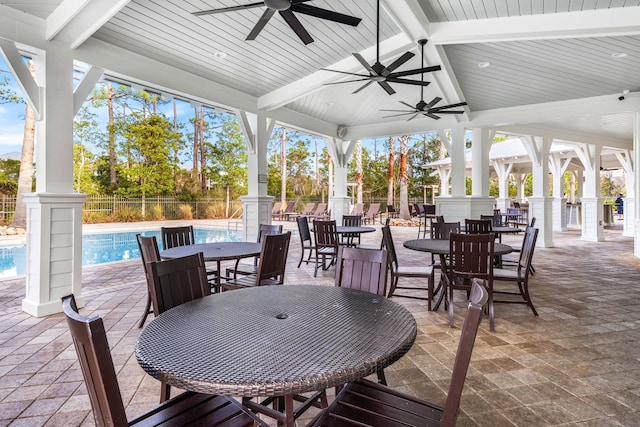 view of patio / terrace featuring a fenced in pool and ceiling fan