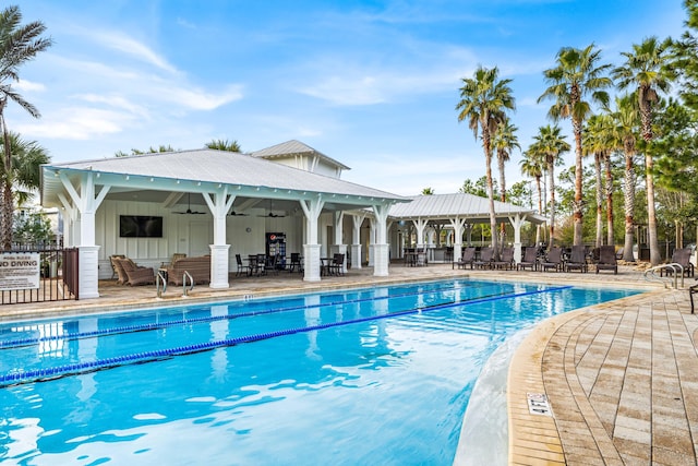 view of pool with a gazebo, ceiling fan, and a patio area