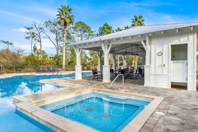 view of swimming pool featuring a patio area, a hot tub, and ceiling fan