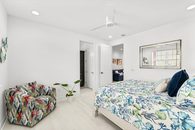 bedroom with ceiling fan and light wood-type flooring