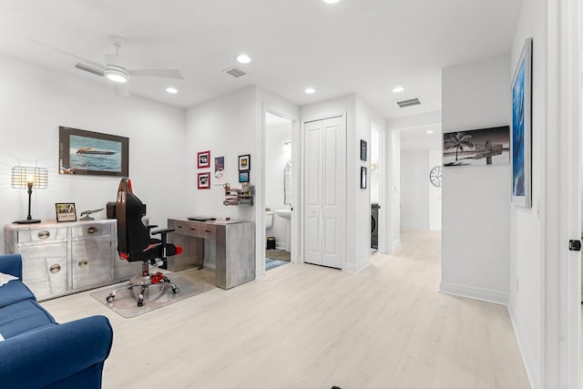 office area with ceiling fan and light hardwood / wood-style floors