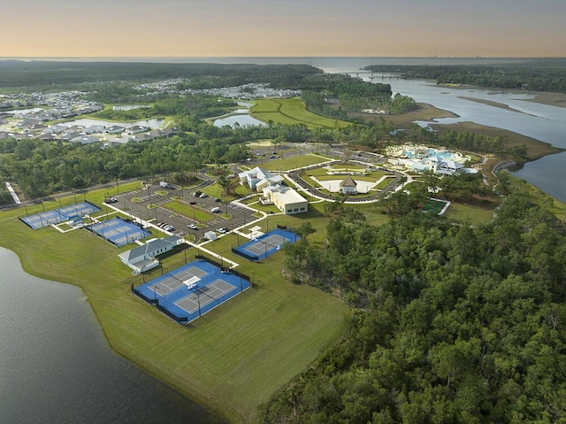 aerial view at dusk featuring a water view