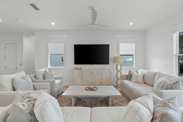 living room featuring crown molding, ceiling fan, hardwood / wood-style flooring, and a wealth of natural light