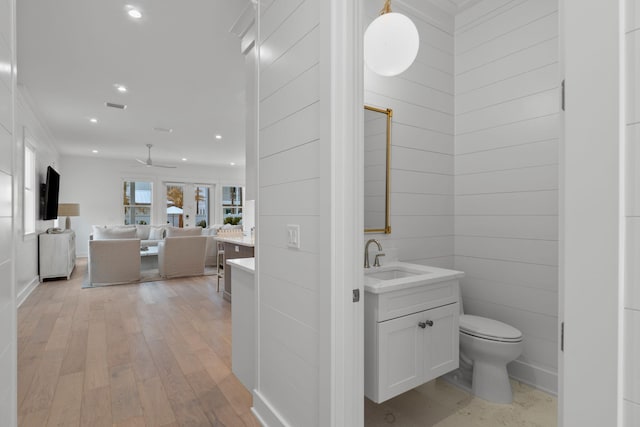 bathroom with vanity, hardwood / wood-style floors, toilet, and ceiling fan