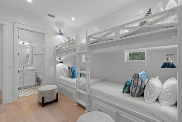 bathroom featuring vanity, hardwood / wood-style floors, crown molding, and toilet