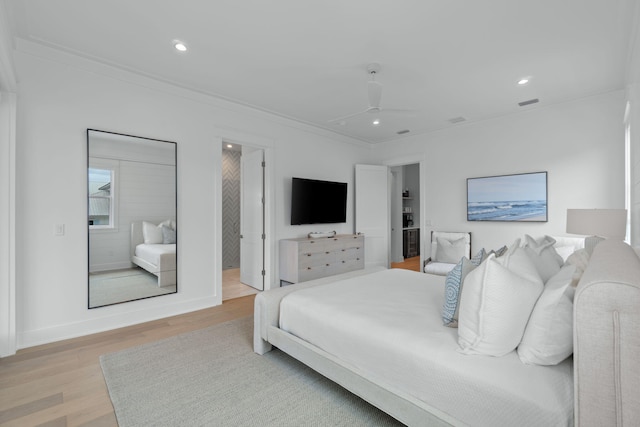 bedroom with ceiling fan, ornamental molding, and light hardwood / wood-style flooring