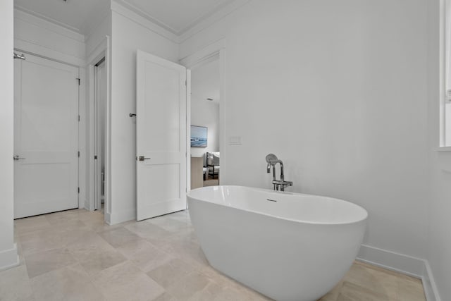 bathroom featuring crown molding and a tub