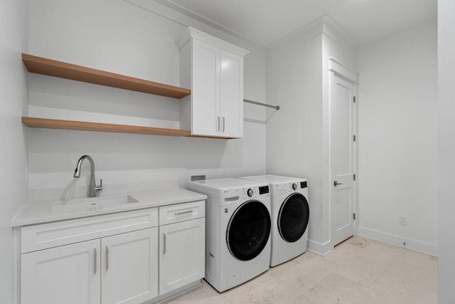 washroom featuring cabinets, crown molding, sink, and washer and clothes dryer