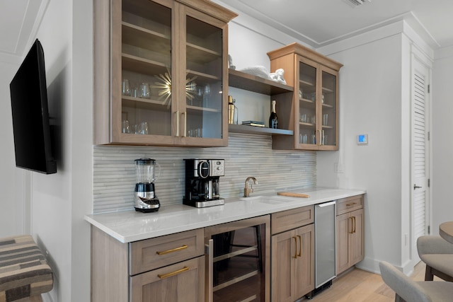 bar with tasteful backsplash, sink, wine cooler, and light wood-type flooring