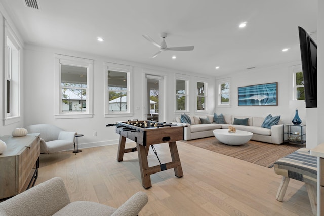 recreation room featuring ceiling fan and light hardwood / wood-style flooring