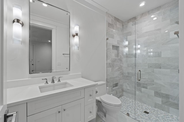 bathroom with vanity, an enclosed shower, and toilet