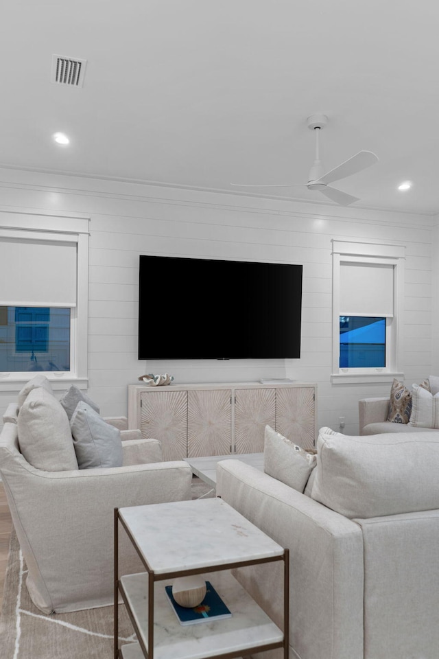 living room featuring ornamental molding and ceiling fan