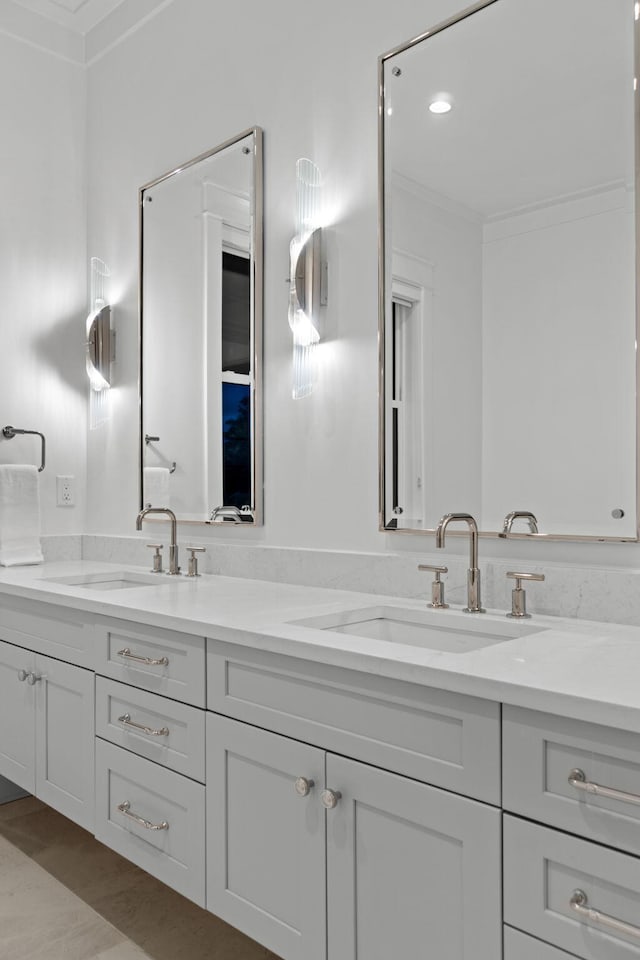 bathroom featuring crown molding, hardwood / wood-style floors, and vanity