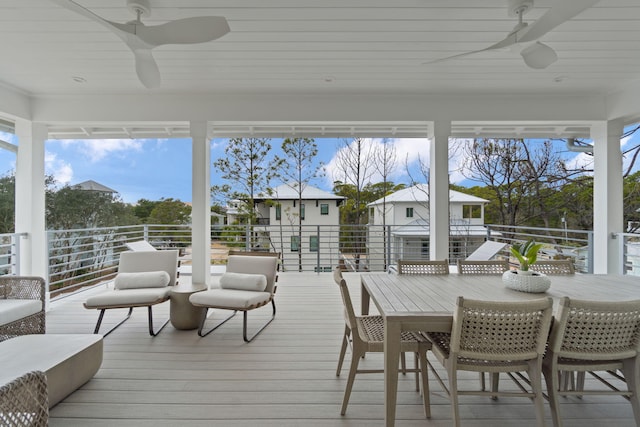 sunroom / solarium featuring ceiling fan