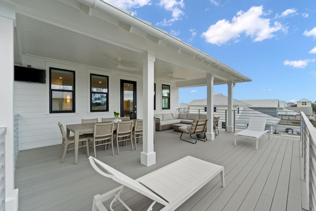 deck with an outdoor living space and ceiling fan