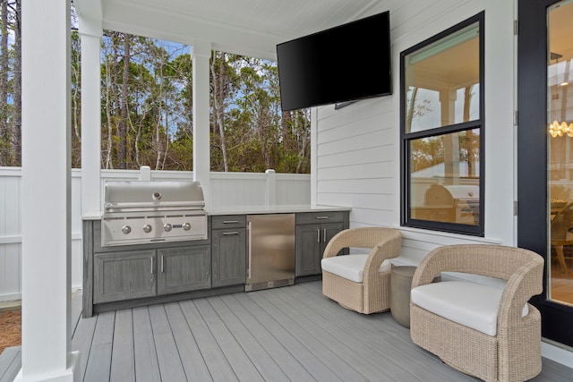 wooden deck featuring grilling area and exterior kitchen