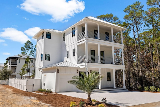 view of front of property featuring a garage and a balcony