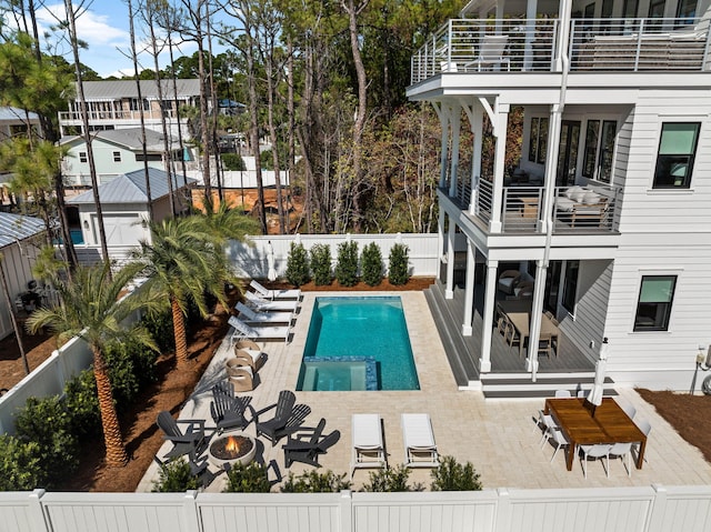 view of swimming pool with a fire pit and a patio