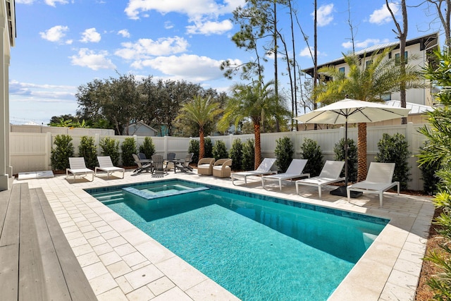 view of swimming pool with an in ground hot tub and a patio area