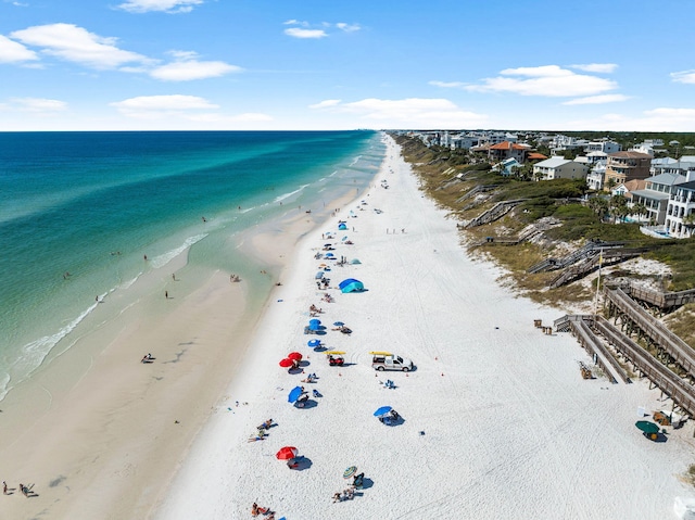 drone / aerial view with a water view and a beach view