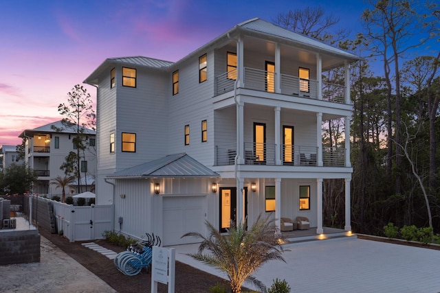 91 Pelayo Ave, Santa Rosa Beach, FL 32459 - view of front facade featuring a balcony, covered porch, a gate, and board and batten siding