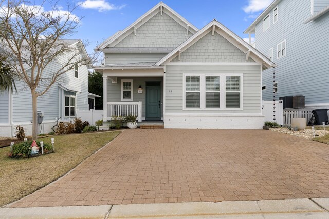 view of front of home featuring central AC unit, a front yard, and a porch