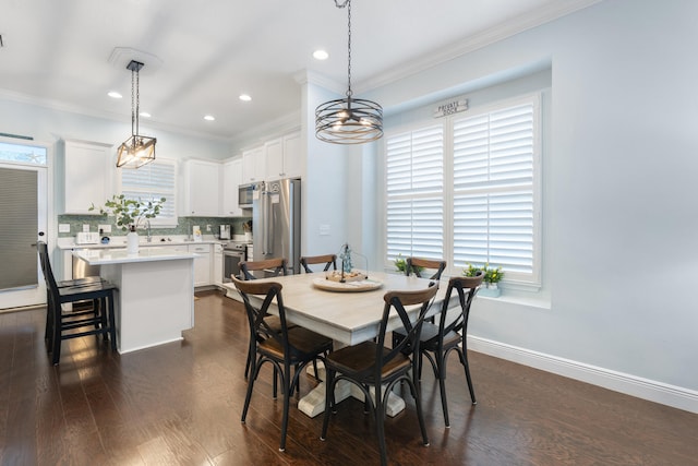 dining room with ornamental molding, dark wood-type flooring, and sink