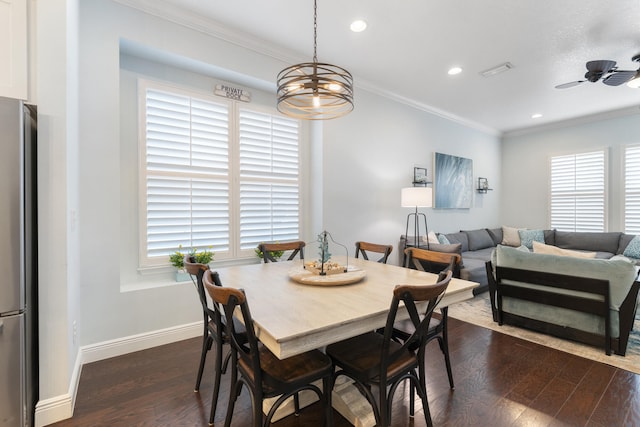 dining space featuring dark hardwood / wood-style flooring, crown molding, plenty of natural light, and ceiling fan