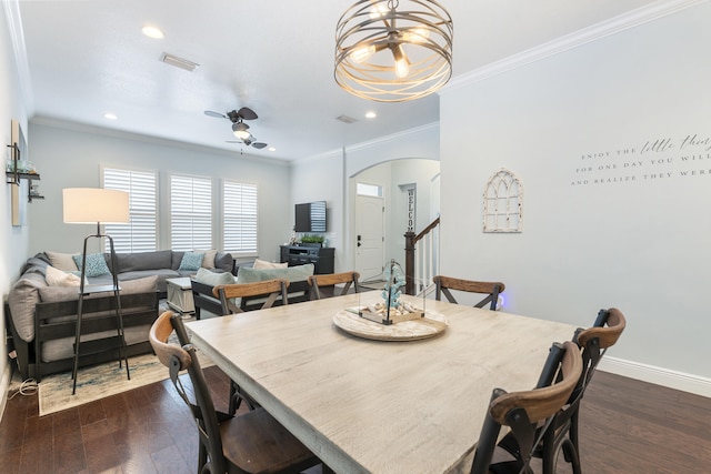 dining room with crown molding, ceiling fan with notable chandelier, and dark hardwood / wood-style flooring