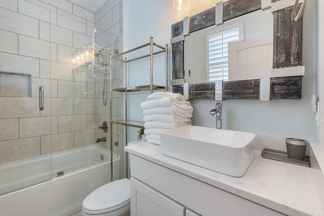 full bathroom featuring vanity, toilet, and combined bath / shower with glass door