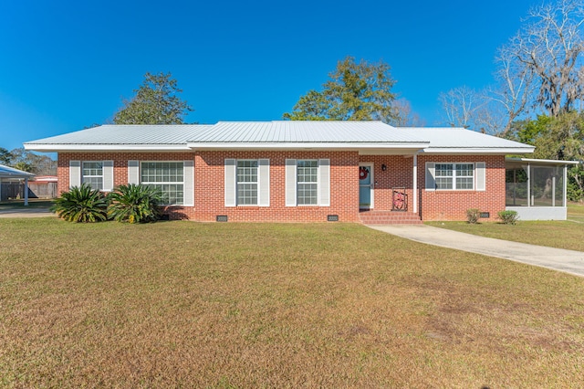 ranch-style home with a sunroom and a front yard