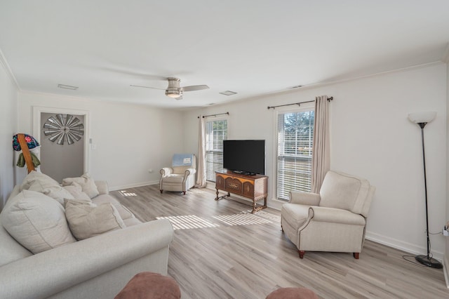 living room with crown molding, ceiling fan, and light hardwood / wood-style flooring