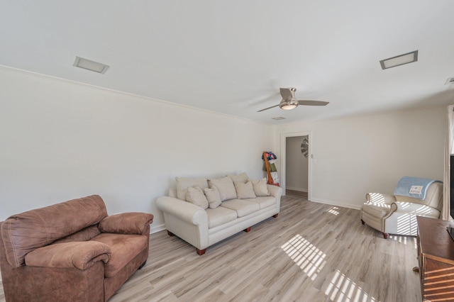 living room with ceiling fan and light hardwood / wood-style floors