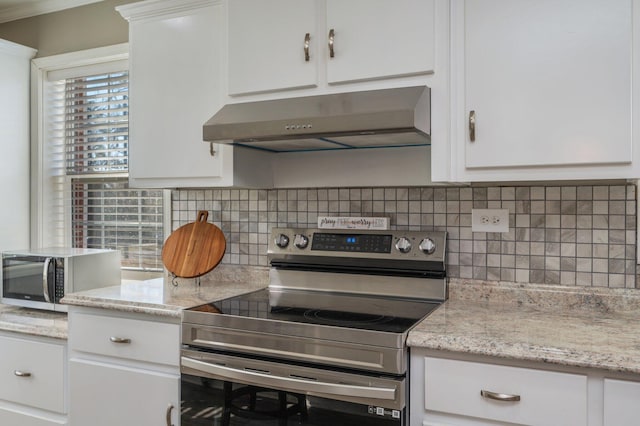 kitchen featuring white cabinetry, appliances with stainless steel finishes, backsplash, and light stone counters