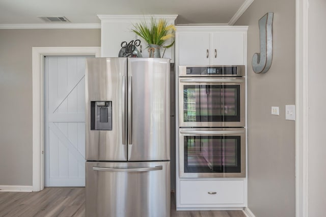 kitchen featuring crown molding, appliances with stainless steel finishes, light hardwood / wood-style floors, and white cabinets