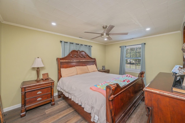 bedroom featuring ornamental molding, ceiling fan, and dark hardwood / wood-style flooring