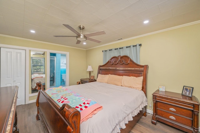 bedroom featuring hardwood / wood-style floors, ornamental molding, and ceiling fan