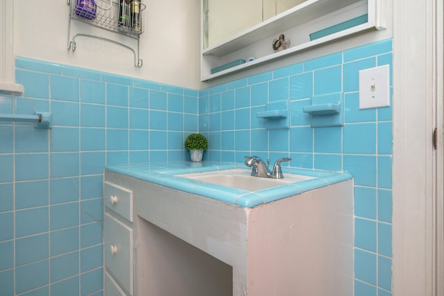 bathroom with vanity and tile walls