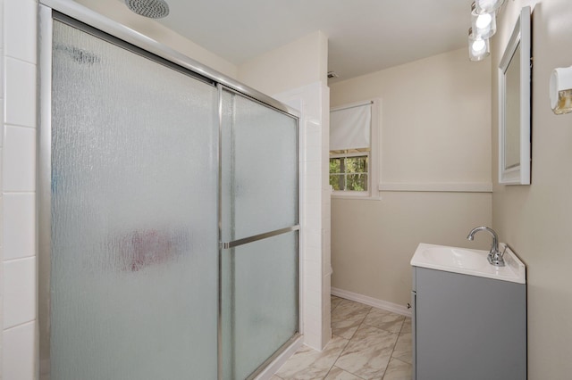 bathroom featuring vanity and a shower with door