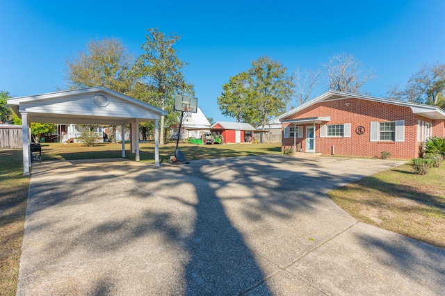 view of home's exterior with a carport and a lawn