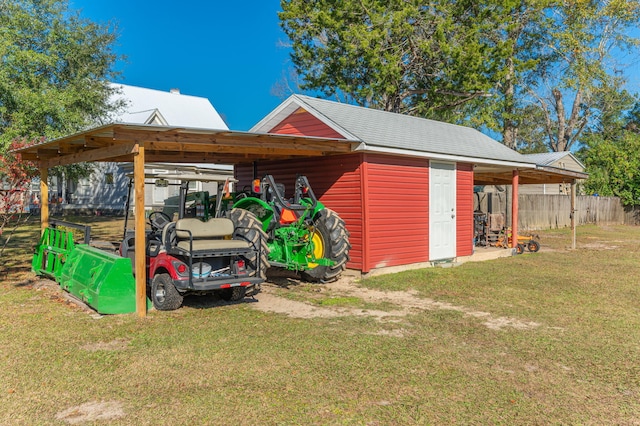 view of outdoor structure featuring a carport and a lawn