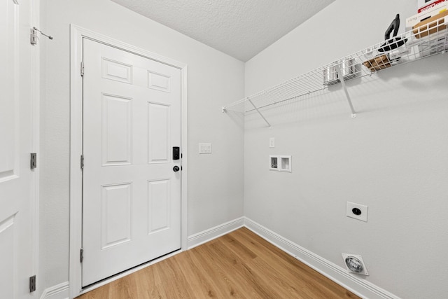 laundry area featuring hardwood / wood-style flooring, hookup for a washing machine, hookup for an electric dryer, and a textured ceiling