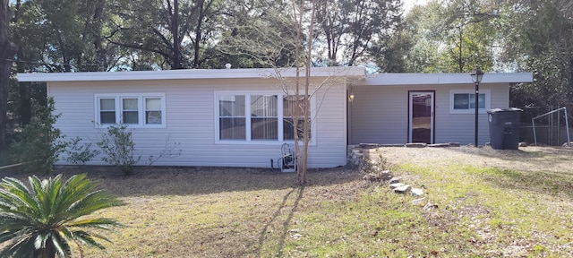 back of property featuring a lawn