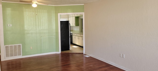 unfurnished room featuring crown molding, wood-type flooring, and ceiling fan