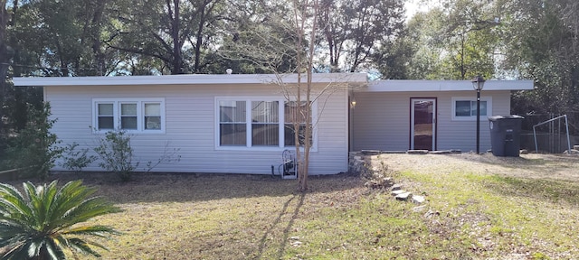 back of house featuring a lawn