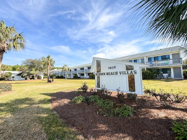 community sign featuring a lawn