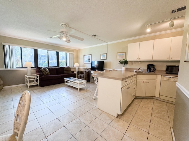 kitchen featuring dishwasher, white cabinets, a textured ceiling, light tile patterned flooring, and kitchen peninsula