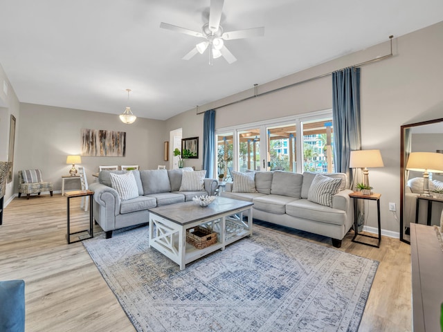 living room with light hardwood / wood-style floors and ceiling fan