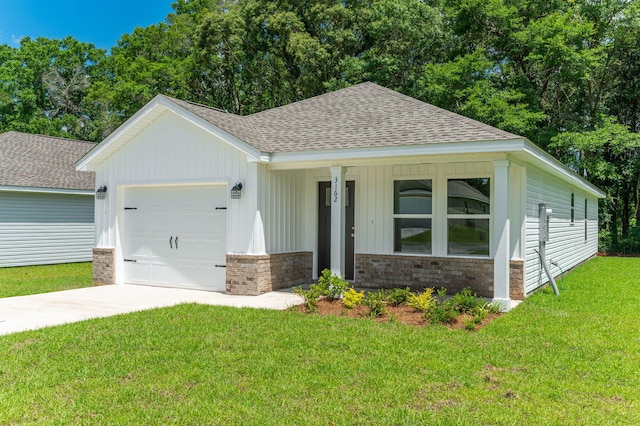 ranch-style house featuring concrete driveway, a shingled roof, a garage, and a front yard